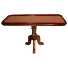 An original mahogany ship’s side table with cast iron base
