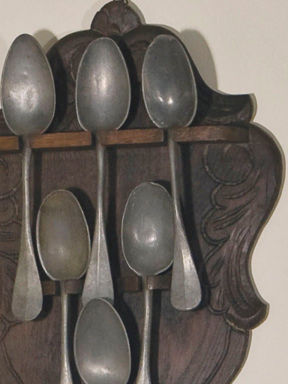 carved oak spoon holder for six pewter spoons.