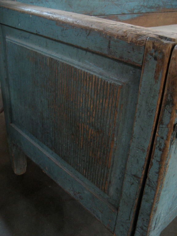 This is a Swedish trundle bed circa 1800.  Original wood frame with light turquoise painting.  Worn natural seat.