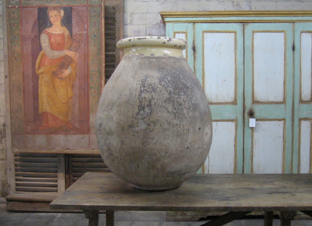 This is a pair of early 19th c. biots, or terracotta pots usually used for olive oil.  Very large scale.  Creamy yellow glaze at mouth of pots.  Great as floor or table decoration.