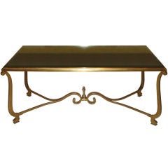 Scrolled bronze coffee table with antique mirrored top