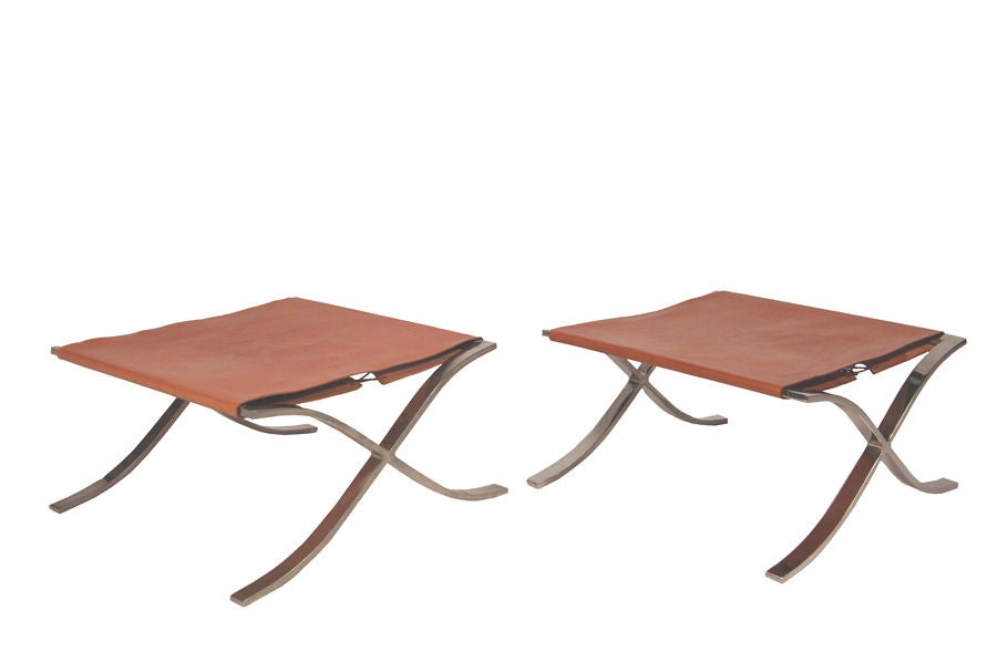 Designed in 1928 by Mies van der Rohe, this pair is vintage 1970's. Stainless steel x-frame occasional stools with natural leather sling seat and leather lacing. Made by Knoll Associates.