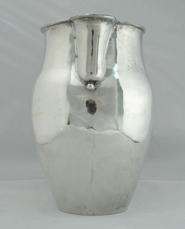 A large and impressive early 20th century William Spratling sterling silver pitcher. 1940 - 1946. Hallmarks: Spratling Made in Mexico. Spratling Silver.<br />
<br />
Dimensions: 9.5 inches high. 941.6 grams.