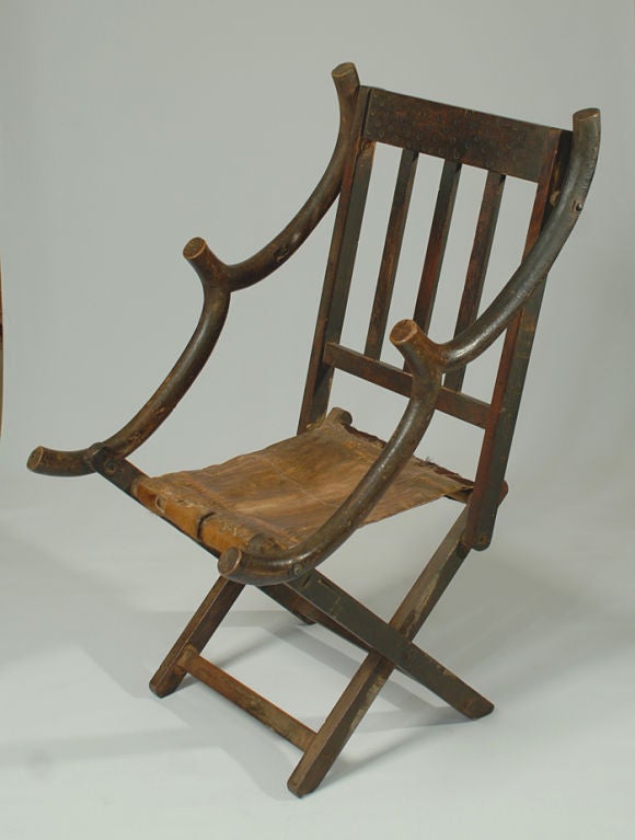 A rare early 20th century Hehe 'acrobatic' folding chair and foot stool - a design inspired by colonial camp chairs. Tanzania, circa 1910.<br />
<br />
Dimensions: 39 inches high x 22 inches wide x 27.5 inches deep. Foot stool measures 16 inches
