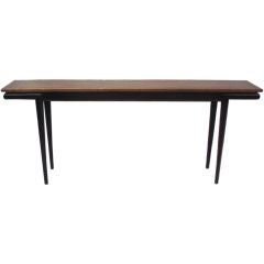 A Walnut and Ebonized Console Table by Michael Taylor