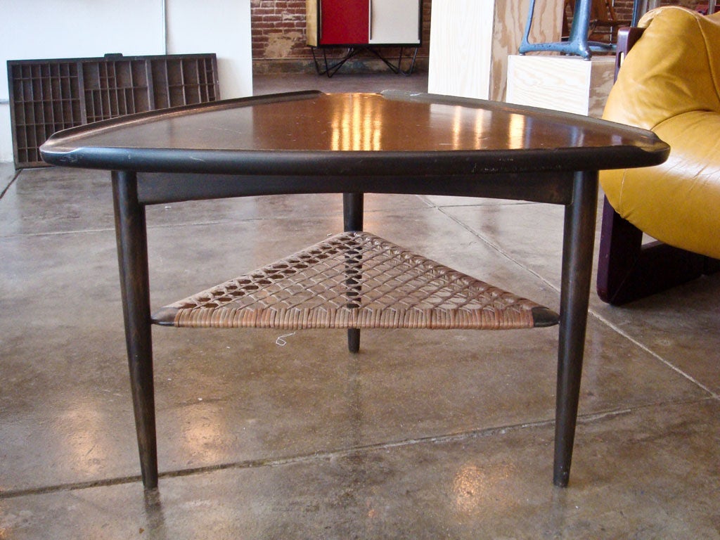 three-legged, triangular side table in walnut in the manner of Edward Wormley