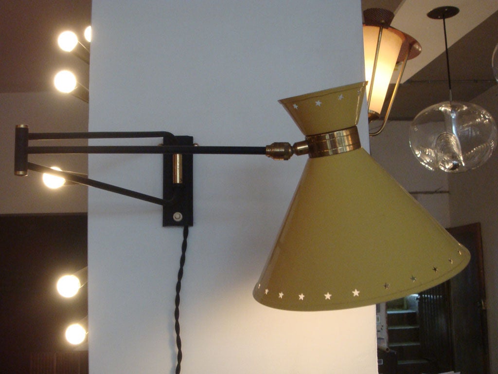 enameled metal and brass double cone swing arm sconce<br />
currently corded<br />
backplates can be fabricated for US junction box<br />
segment lengths: 11