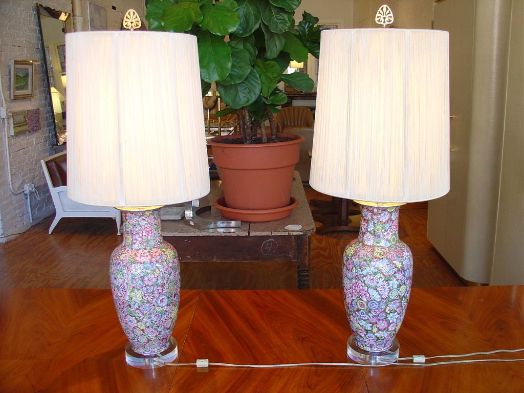 A pair of bright vivid Chinese painted enamel millefleurs lamps on Lucite bases. Shades not included.
The vases date to the 1930s and were converted to lamps in the 1970s.