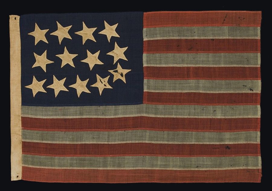 RARE AND BEAUTIFUL 13 STAR, CIVIL WAR PERIOD FLAG <br />
WITH A PERIMETER OF STARS THAT FORM THE LETTER “U” FOR “UNION”.  ENTIRELY HAND-SEWN AND IN A RARE SMALL SIZE, 1861-65:<br />
<br />
13-star American national flag of the Civil War period