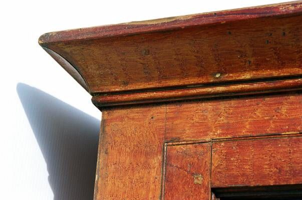PENNSYLVANIA DUTCH CUPBOARD IN BITTERSWEET ORANGE PAINT, WITH SPONGED DECORATION, ON TURNED FEET, FOUND IN READING, PA, 1840-1870:<br />
 <br />
Made ca 1840-1870, this Berks County, Pennsylvania Dutch cupboard has bittersweet orange paint with