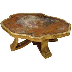 A Cocktail Table in Petrified Wood and Hammered Gilt Bronze