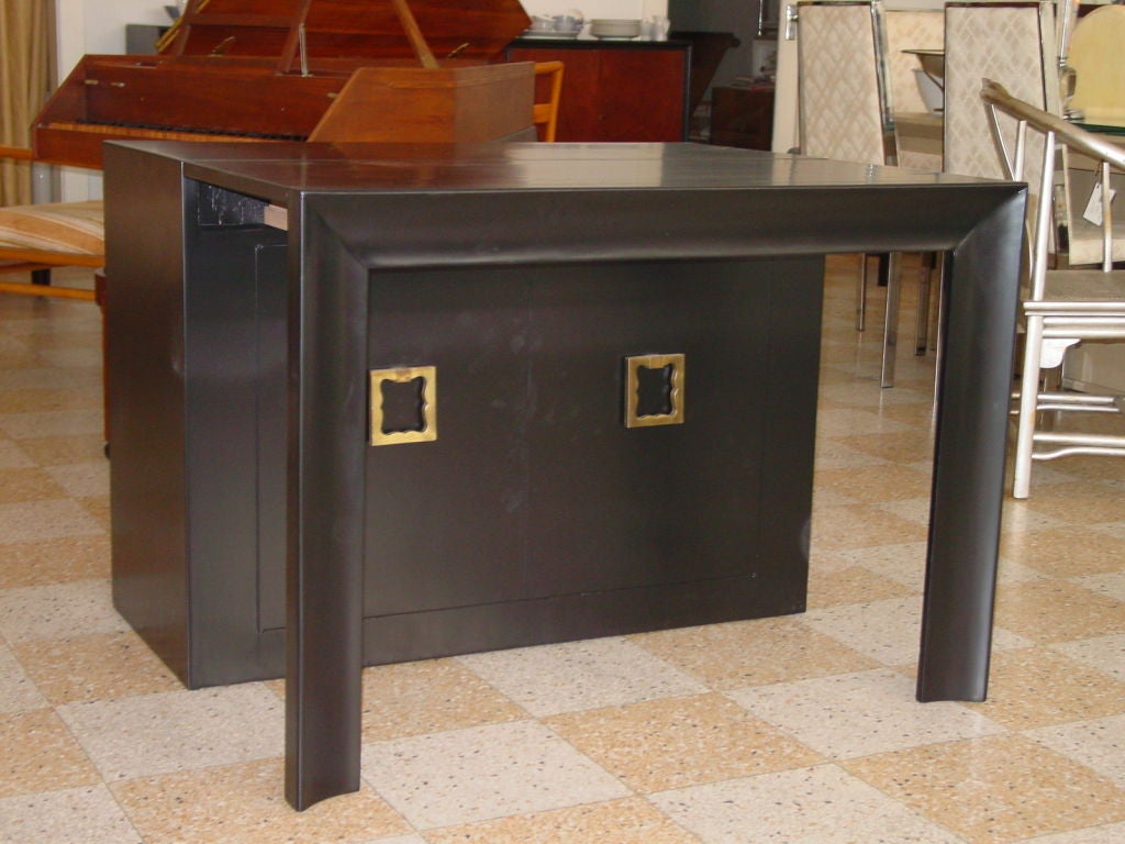 Incredibly versatile dining table that collapses into a small scale server, with a kind of Dorothy Draper inspired look. Three individual leaves are each 17.5