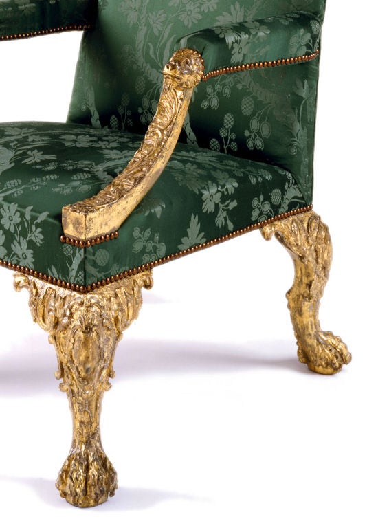 Superb George II carved giltwood Gainsborough chair, the downswept arms with scrolling leaf armrests capped with lionsheads,resting on finely carved front and back cabriole legs with cartouche carved knees and articulated hairy paw feet