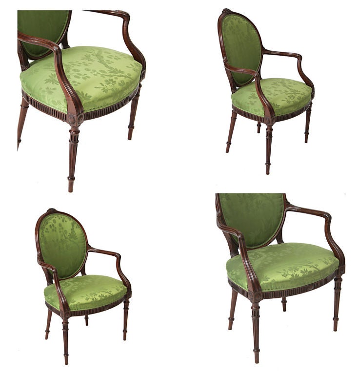 English A George III mahogany oval-backed upholstered open armchair.