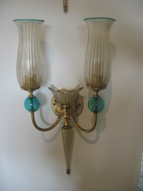 Exceptional pair of 3-light, wall sconces with deep teal colored glass ball accents on the two arms. Murano glass globes with gold dust mixed into the glass paste. Arms are patinated bronze. New wiring. Purchased in Paris.
