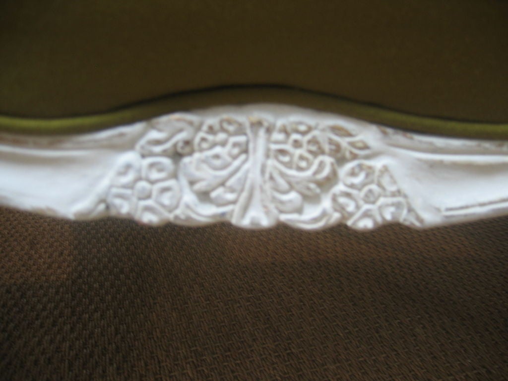 Beautifully carved settee with classic Rococo detailing. Cabriole legs on front as well as the back. Floral carving on the crest and chair rails. Contemporary green upholstery with tufted seat back.
