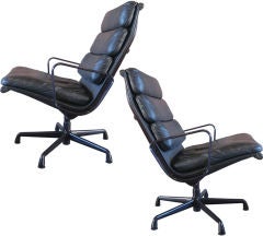 Pair of leather soft pad lounge chairs with eggplant frames