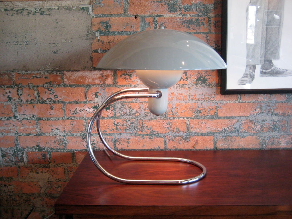 Greta von Nessen's biggest claim to fame came after Walter's death in 1943.<br />
Her metal Anywhere Lamp with enameled dome, which could hang on the wall or<br />
sit on table, was released in 1951. This lamp is a newer production.