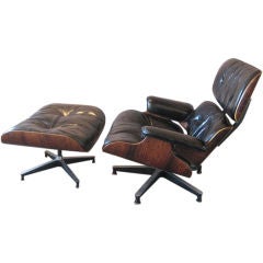 Early rosewood lounge chair and ottoman by Charles Eames