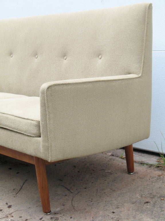 Sofa with exposed walnut frame. Designed by Jens Risom for Risom designs.
