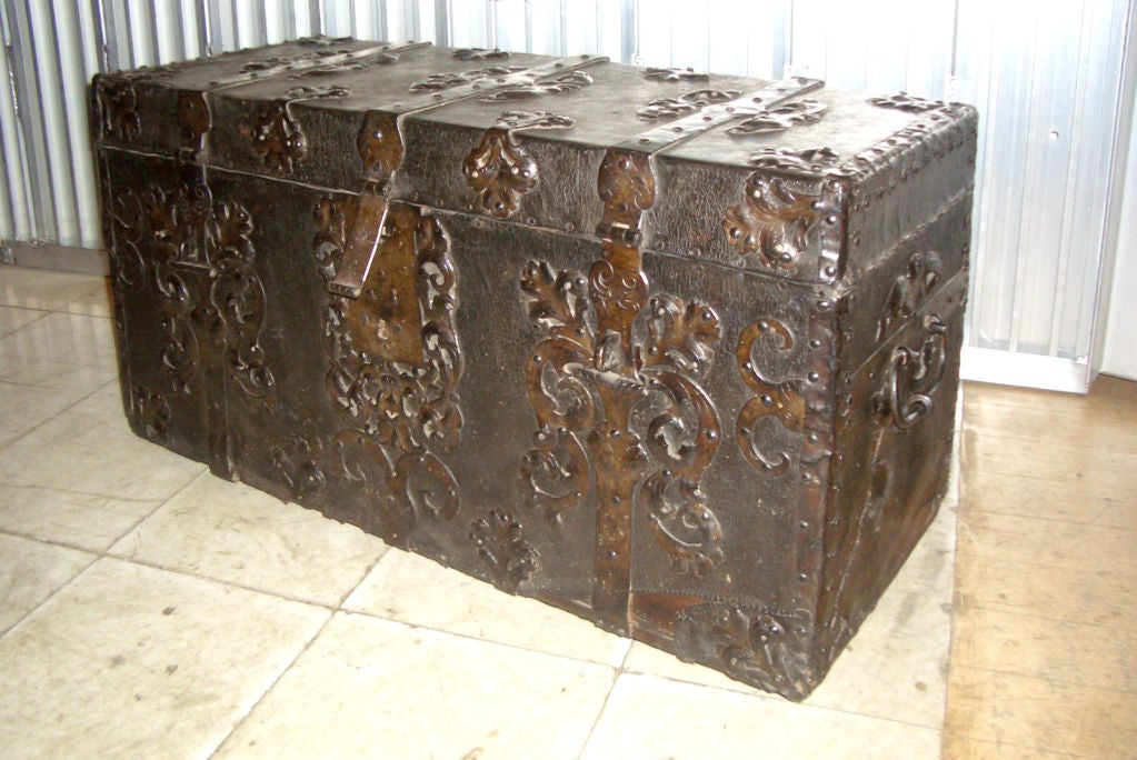 Decorative rare Coffer / Blanket Chest. Covered with the Original Leather and beautiful, Decorative Wrought Iron Work. Fitted interior.
Equally suited for storage or as side / small coffee table.
