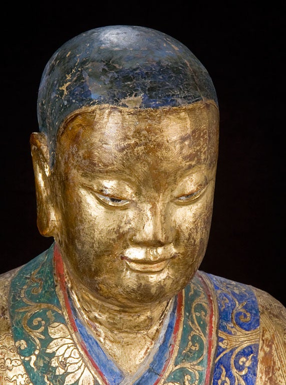 Large Chinese Gilt and Painted Seated Luohan With Both Hands Folded in a Worshipful Dhyana Mudra Position.  The Handsome Face is in Meditative Repose.  The Robe is Decorated with Relief Dragons.