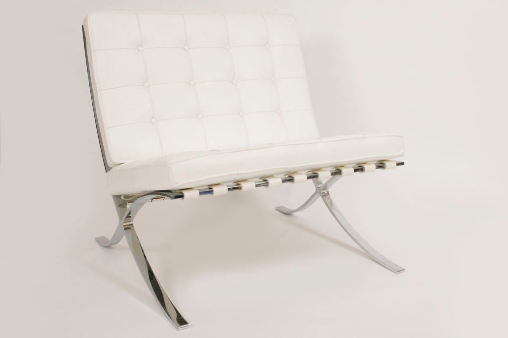 Pair of white leather and sculpted chrome framed Barcelona chairs by Mies van der Rohe for Knoll. These chairs are in excellent original condition and are truly striking in original white leather. Price is for the pair.