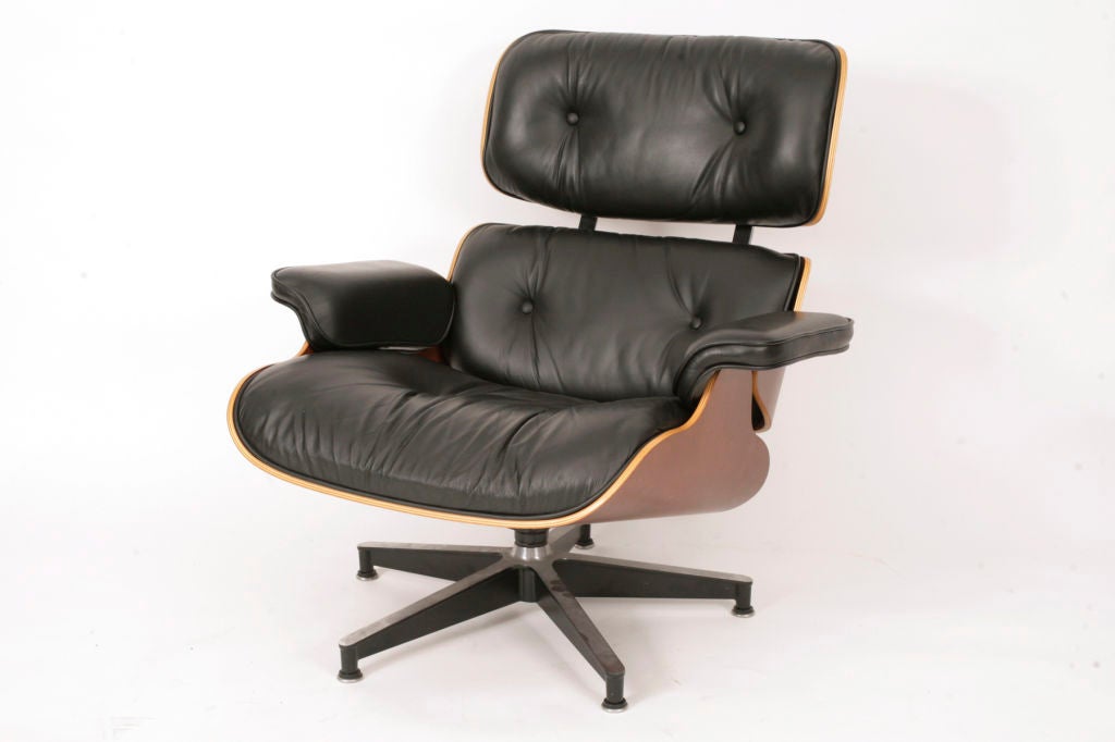 Charles and Ray Eames for Herman Miller 670 chair and 671 ottoman. This example is a newer production model and has supple black leather with dark cherry wood frame. Excellent original condition.