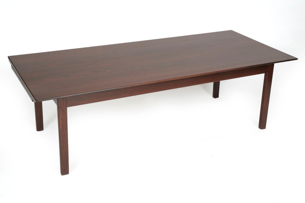 Rosewood extension coffee table from Denmark, circa late 1960s. Features beautifully grained rosewood top and legs with white extension sides that can be fully stored away or extended to add 15