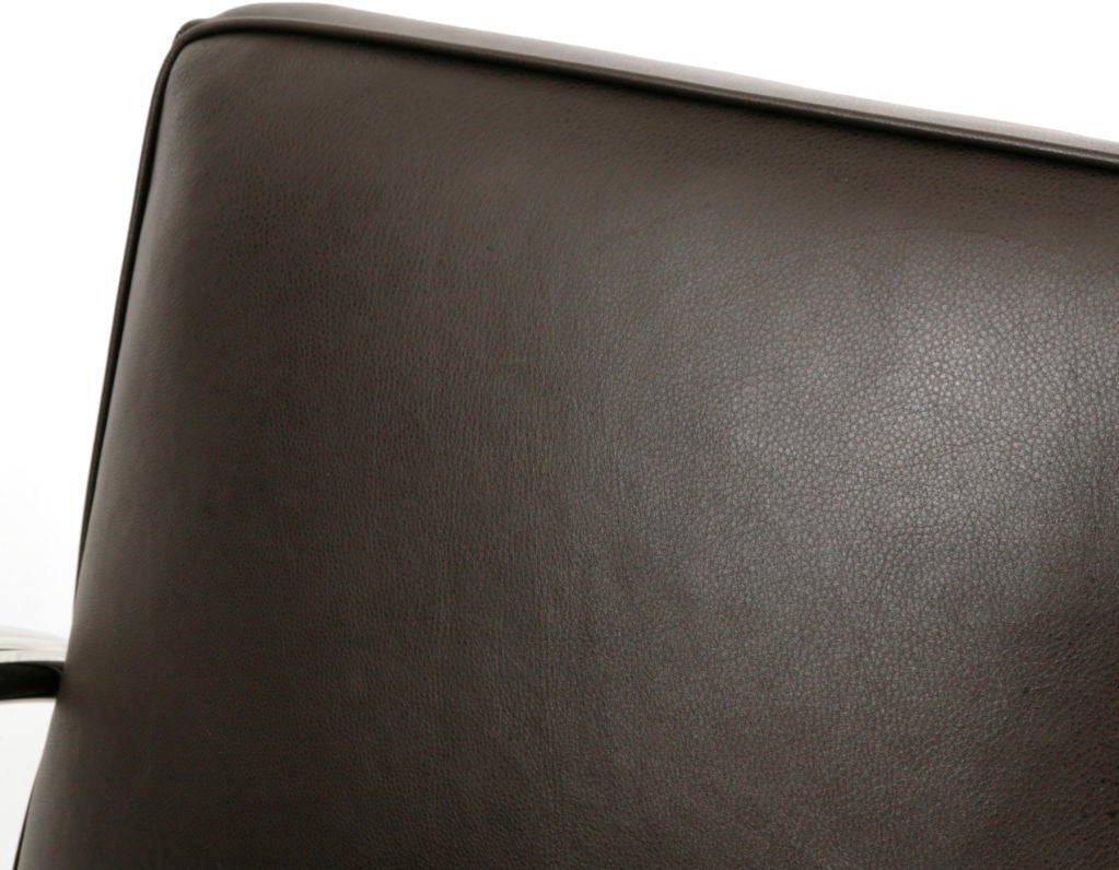 Modeled after the Kem Weber classic of the 1930's this Ralph Lauren lounge chair is elegant and extremely comfortable. The design of the frame features three bands of mirrored chrome and this example is done in a rich chocolate brown leather.