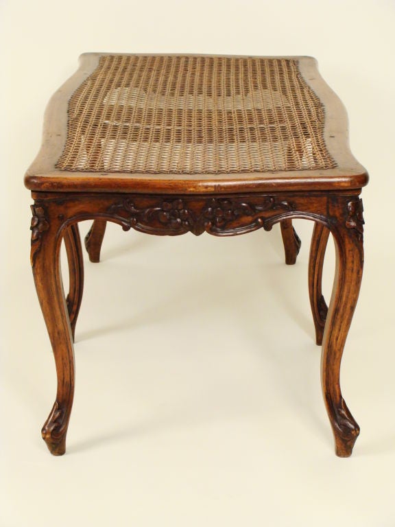 a matched pair of Louis XV provincial carved walnut benches