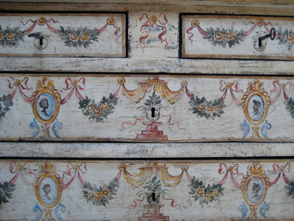 Four drawer chest painted cream with floral swags and cameos.