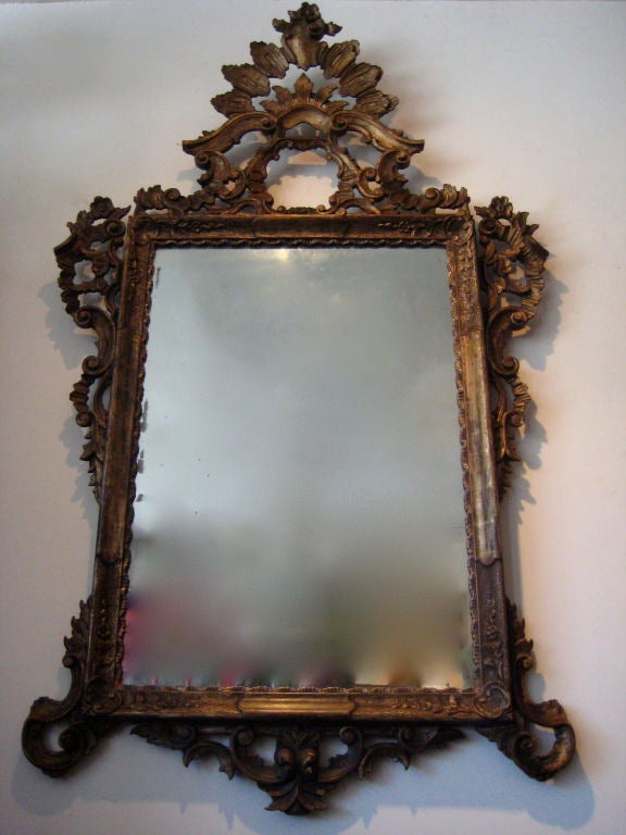 Carved and gilded scroll wood Venetian mirror from Italy.