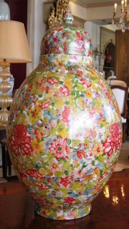 A French 19th century opaline lidded vase with hand painted floral decoration. Red Chrysanthemums are the central theme and are repeated around the center of the vase. Extremely detailed in shades of yellow, green and blue.