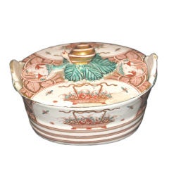 A tin and gold-glazed earthenware oval butter tub and lid