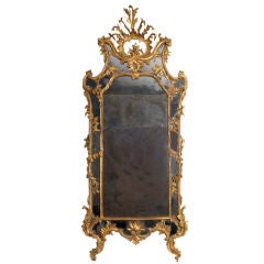 A carved and gilded Rococo mirror with antique mirror glass