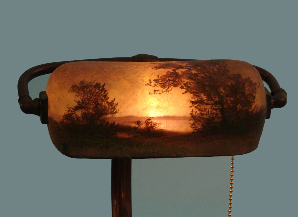 A Handel desk lamp of typical form, fully signed with silk label. Circa 1900. Repairs to base.