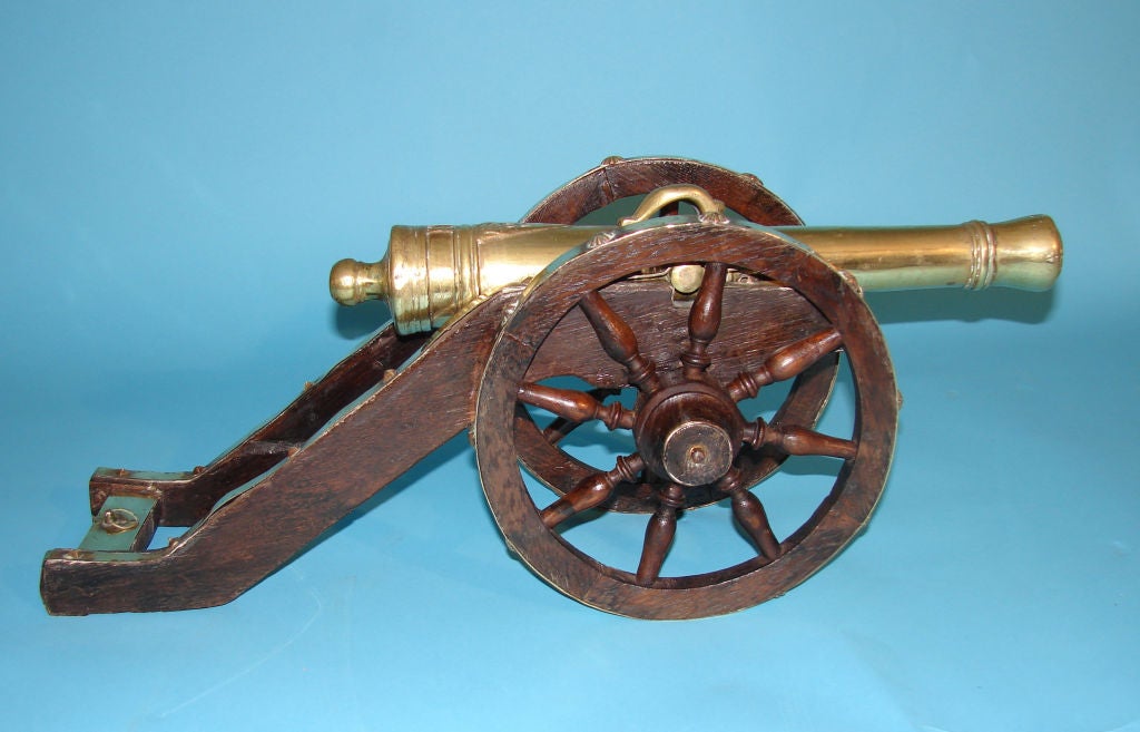 A pair of Continental cast brass signal cannons bearing the date 1670, mounted on decorative oak carriages. Circa 1920-1950.