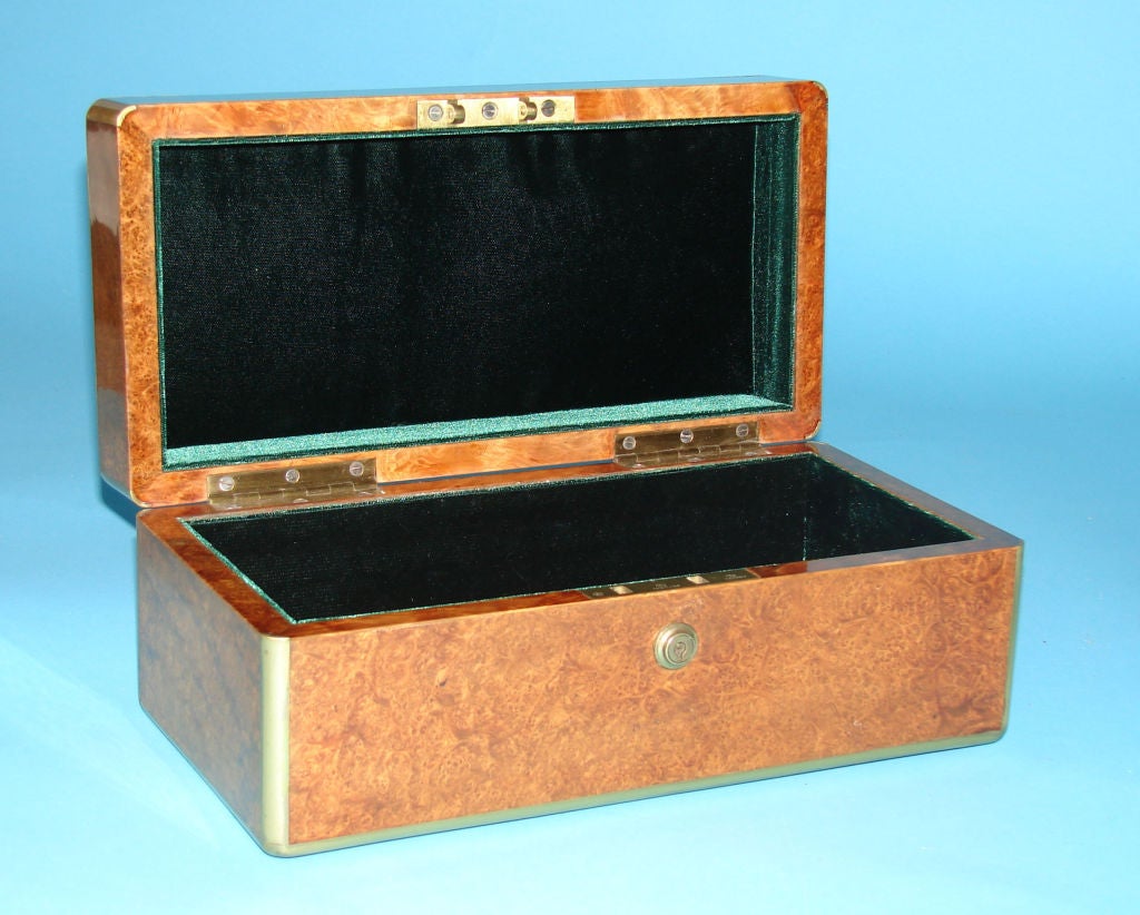 A fine English brass bound thuya wood box, now lined in velvet, retaining its original Bramah lock. Circa 1840.