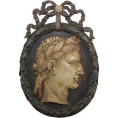 A Continental Painted Wood Oval Portrait Relief of Julius Caesar