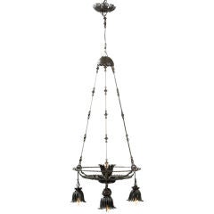 A Wrought Iron 4 Light Chandelier by Alessandro Mazzucotelli