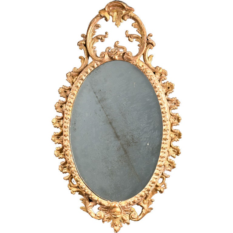 A small oval carved and Carton Pierre mirror For Sale