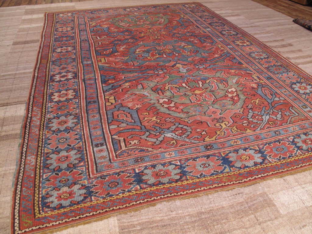 Antique Oushak carpet. An Oushak, carpet or rug, featuring the older design and color palette from this region that predates the western influence and the export boom. Carpet with very handsome interpretation of a classic design. For the