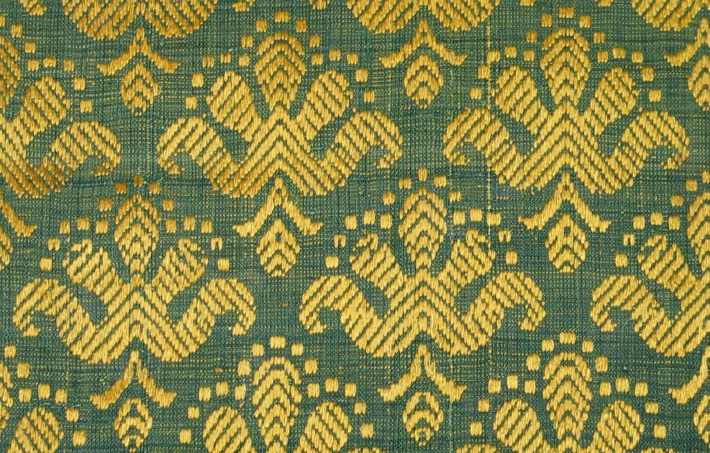 A rare late 17th century Italian linen and silk brocatelle with a blue ground patterned with a yellow silk horizontal repeated stylized floral design.
