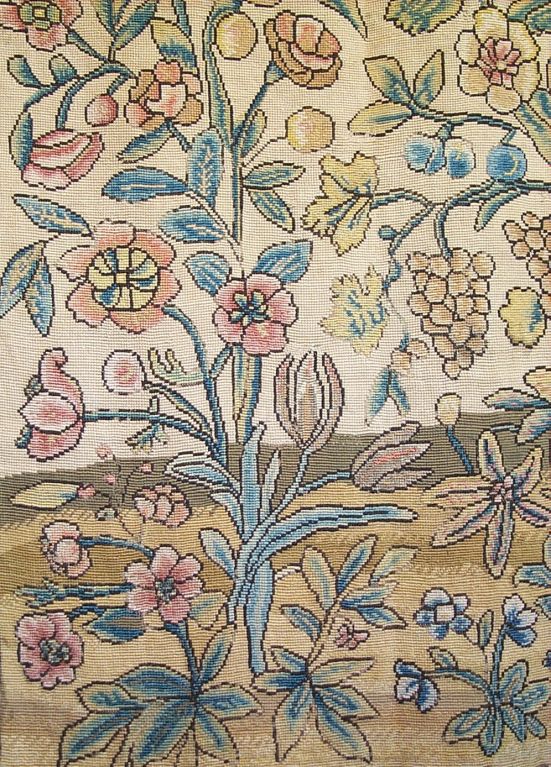 17th century French pair of silk needlepoint panels decorated with grapes, flowers and fruits in blue, green, pink and yellow on a light tan ground.