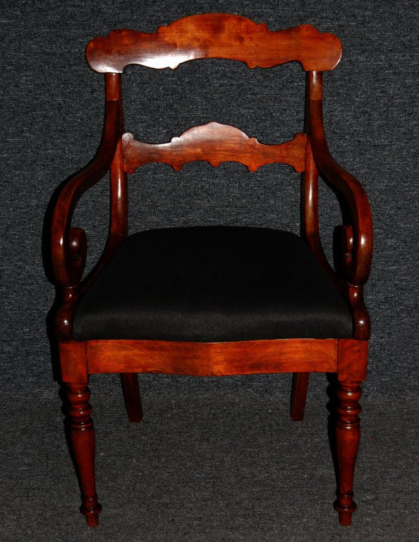 Elegantly period antique Karl Johan (Swedish Biedermeier) carved chair of solid birch with graceful scrolled arms.  Wood has original faux-finish to resemble mahogany and has a wonderful patina.  Upholstery has been rebuilt and covered in high-end