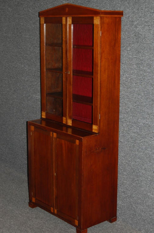 Diminutive glass breakfront cabinet of mahogany with golden birch inlay. Believed to be a cabinetmaker's sample. Back of upper cabinet lined in crimson velvet. Glass is antique and appears to be original. Use as a bookcase, vitrine, curio cabinet,