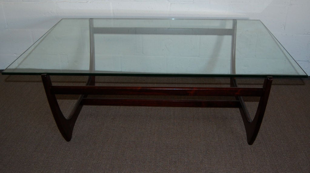 Cantilevered coffee table of jacaranda wood with original glass top by noted Danish designer Børge Mogensen.