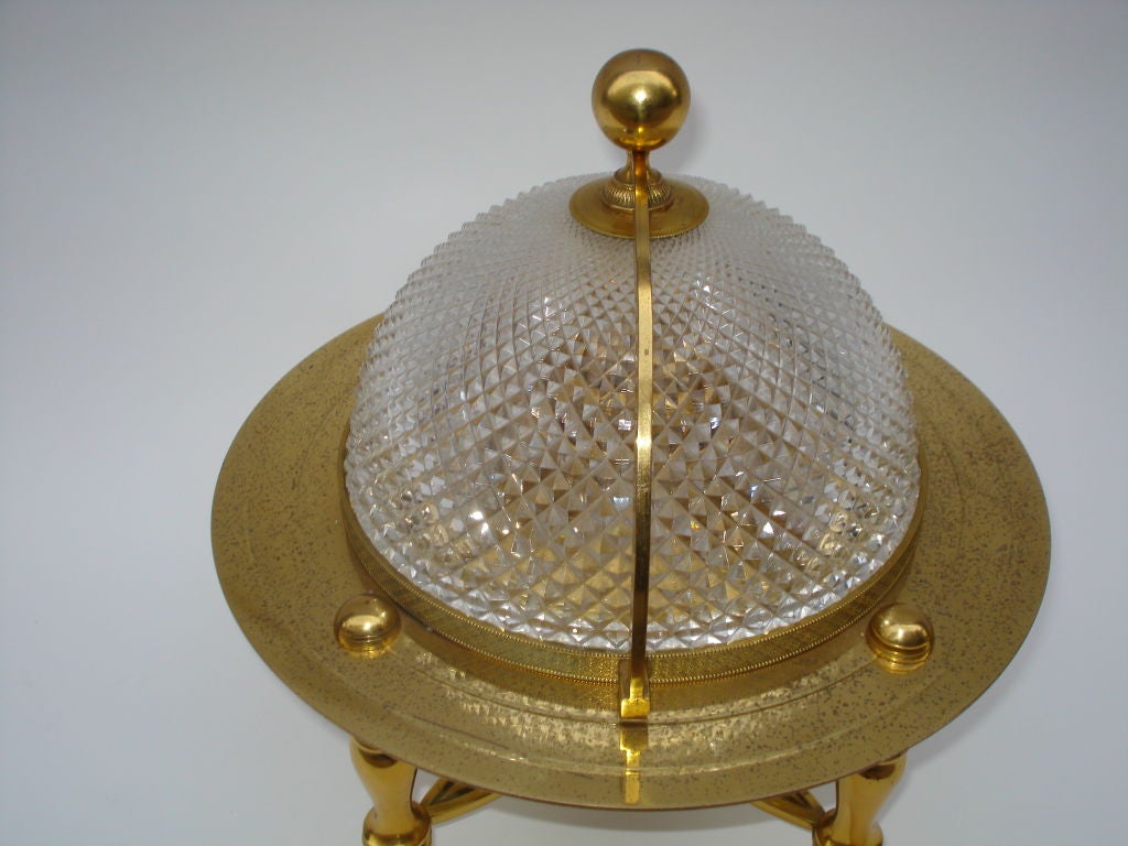 Having a sphere form finial.  The fitted interior has a flattened bronze ring, two decanters, and six goblets.