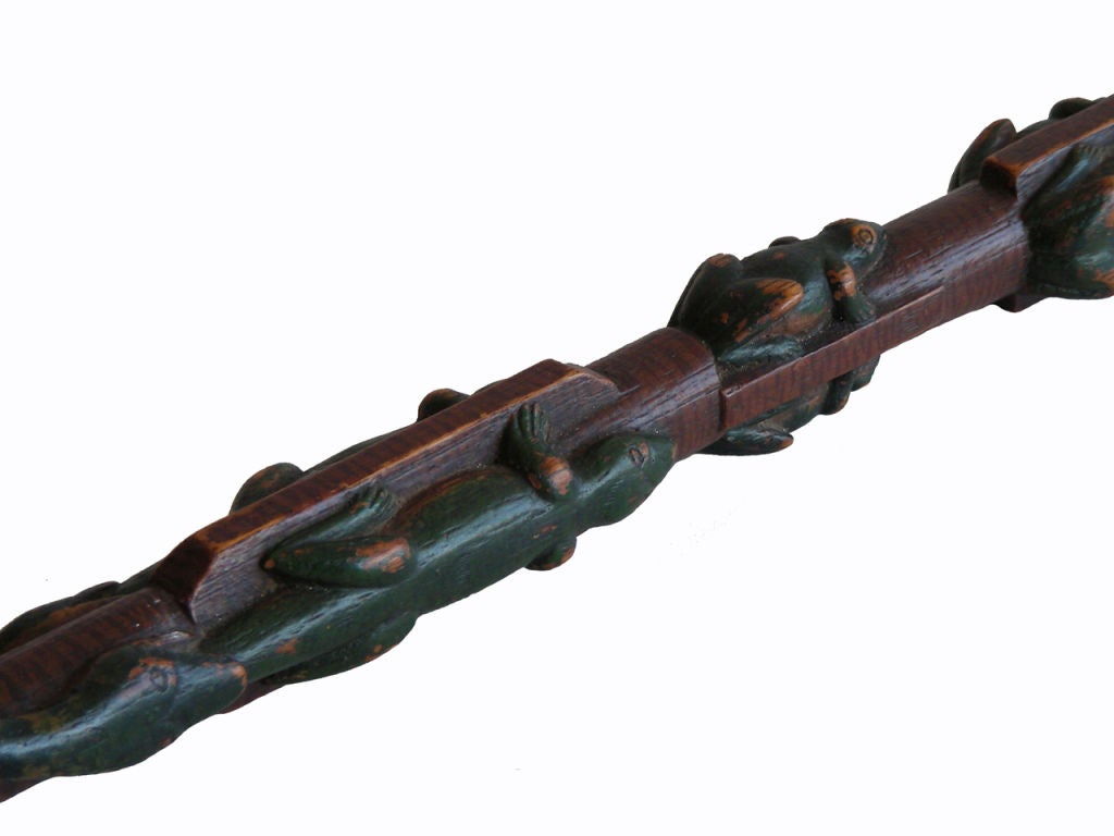 Circa 1860-70 carved walking cane showing two green spotted snakes rising from the base of the cane intertwining until they meet the tails of two green lizards, with the snakes holding the tails of the lizards, giving the appearance that they are
